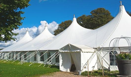 a row of portable toilets placed outdoors for attendees of a special event in Grosse Tete